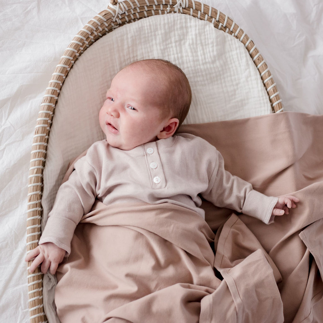 Baby wearing Stretchy Swaddle baby Blanket | Sunset (Organic)