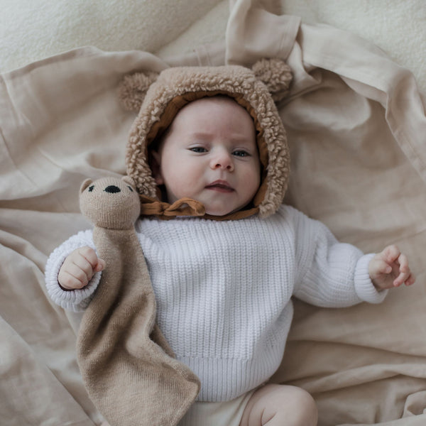 Baby wearing Muslin Swaddle Blanket | Oat (Organic)