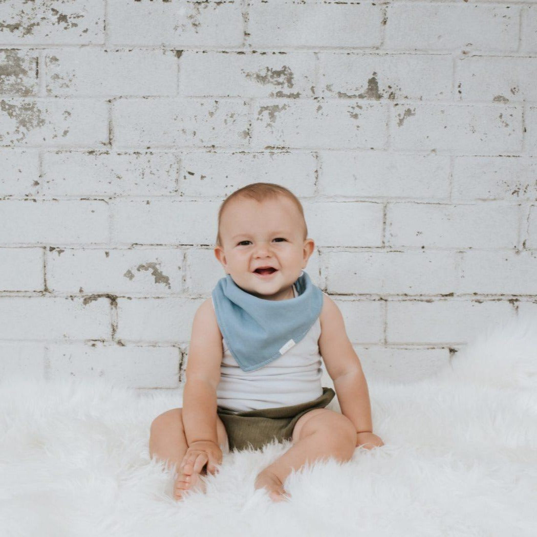 Baby wearing Linen Dribble Bib in blue color