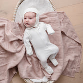 Baby laying on Muslin Swaddle Blanket | Sunset (Organic)