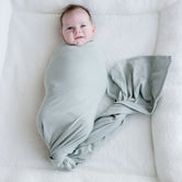 Baby wearing Stretchy Swaddle baby Blanket  | Sage Green (Organic)