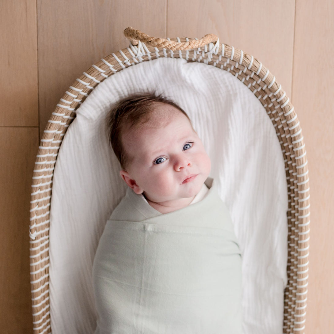 Baby wearing Stretchy Swaddle baby Blanket | Sage Green (Organic)