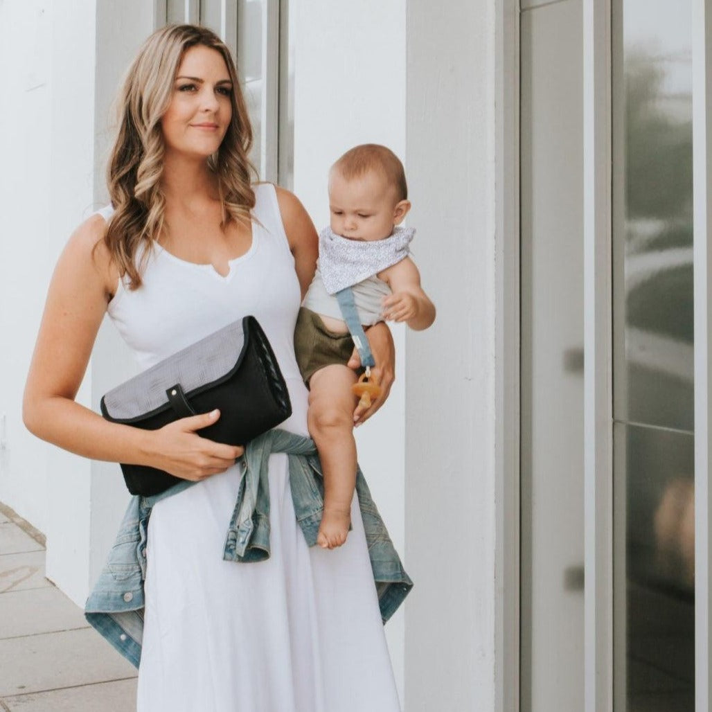 Women showing Nappy Change Mat Clutch | Gridlock Grey