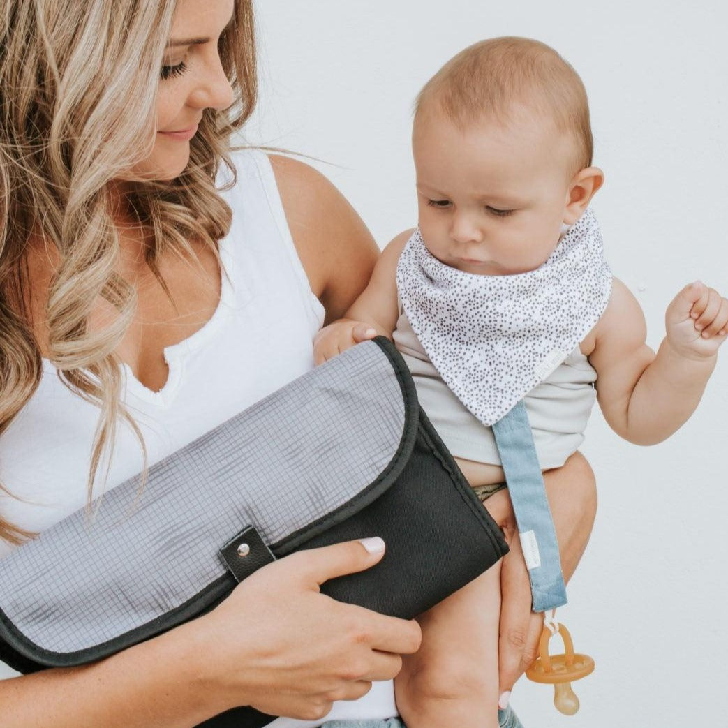 Women showing Nappy Change Mat Clutch | Gridlock Grey