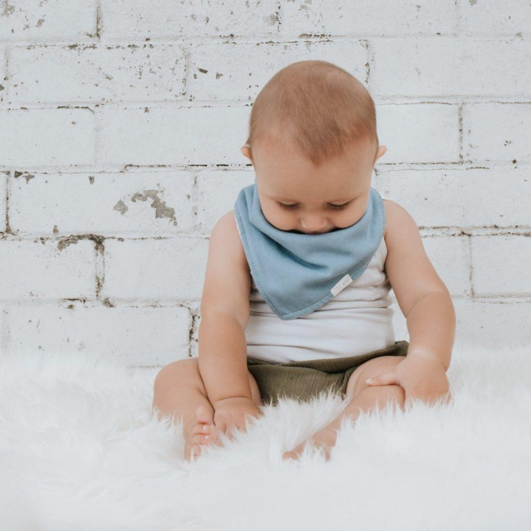 Baby wearing Linen Dribble Bib in blue color