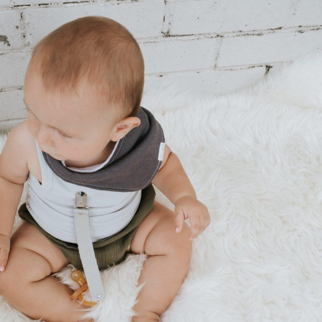 Baby wearing Linen Dribble Bib in gray color
