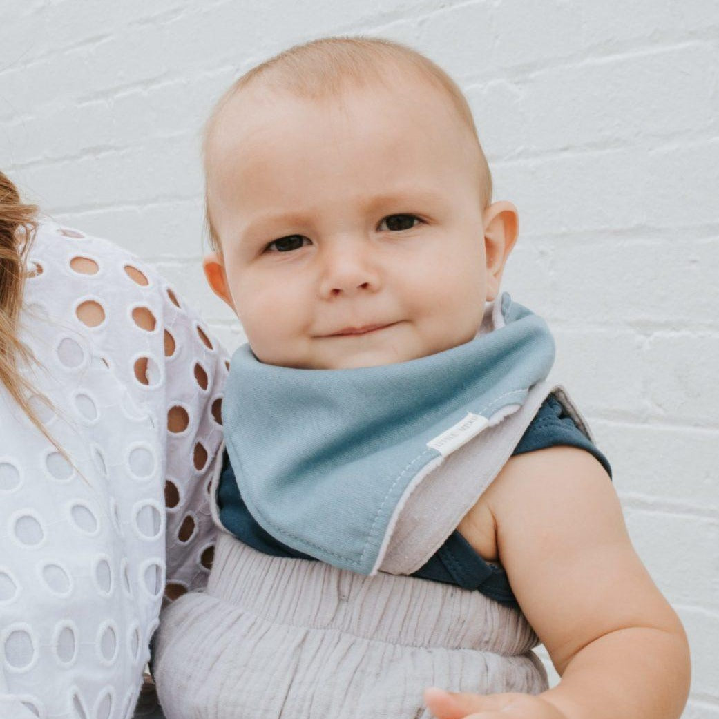 Baby wearing Linen Dribble Bib in blue color