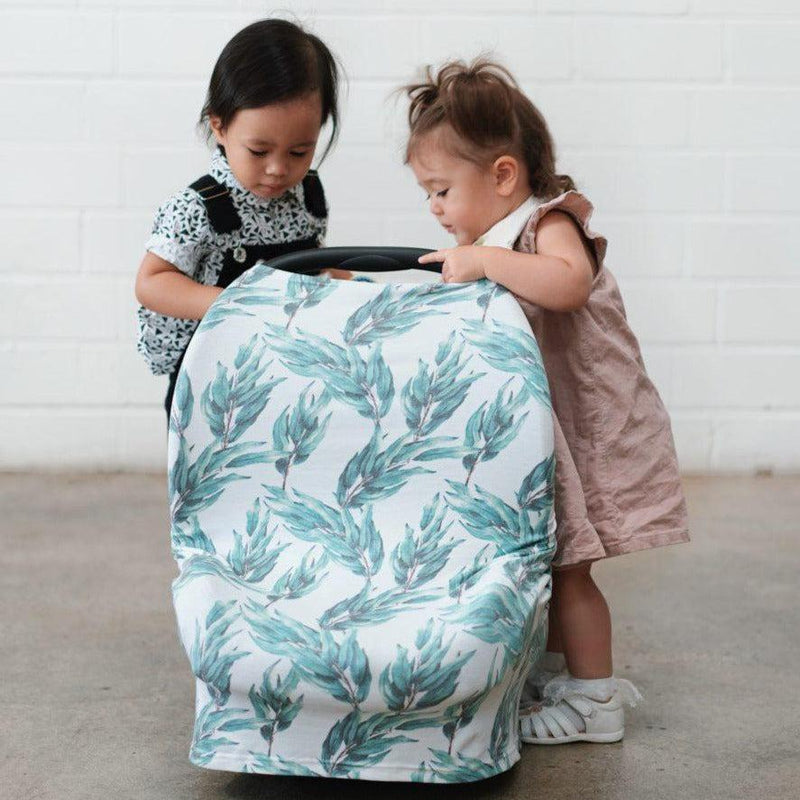 Two babies are watching a baby carrier bag