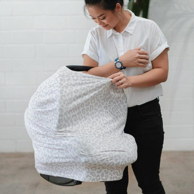 Women holding a white baby carrier bag