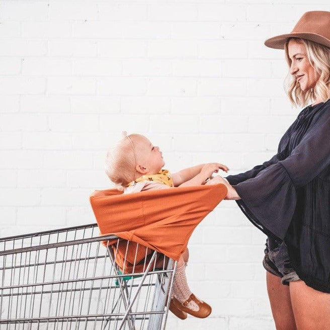 Baby  sitting in 5 -1  Mama Cover in shopping cart